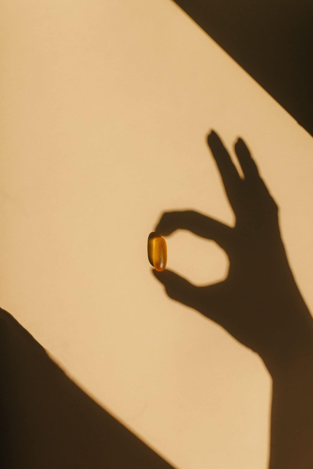 Several magnesium supplement capsules of different colors arranged side by side on a white surface, representing multiple forms in a complex